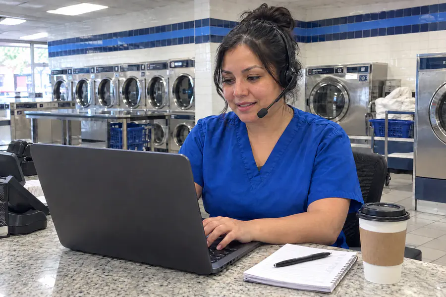Drop & Dash team member answering a customer call at the store's front desk