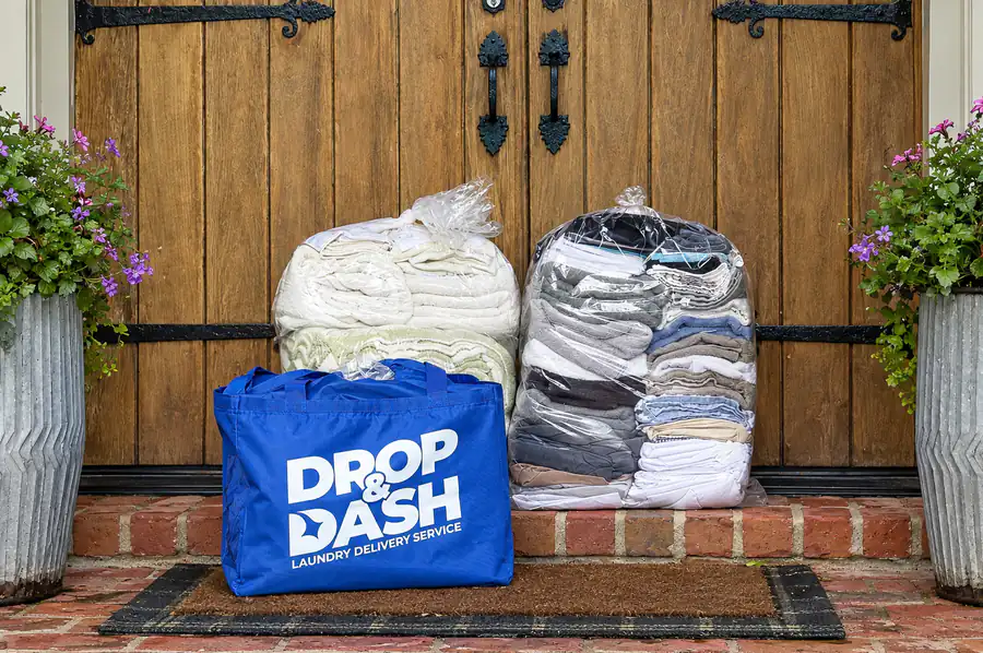 Clean folded laundry returned in a Drop & Dash bag