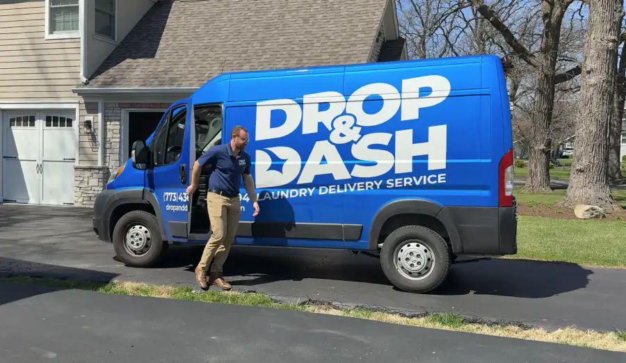 A Drop & Dash driver arriving in a branded delivery van to collect laundry