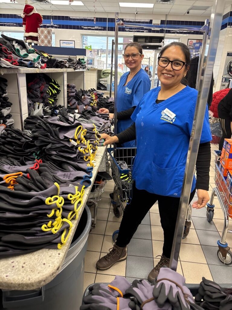 Two Drop & Dash laundry attendants at the folding counter